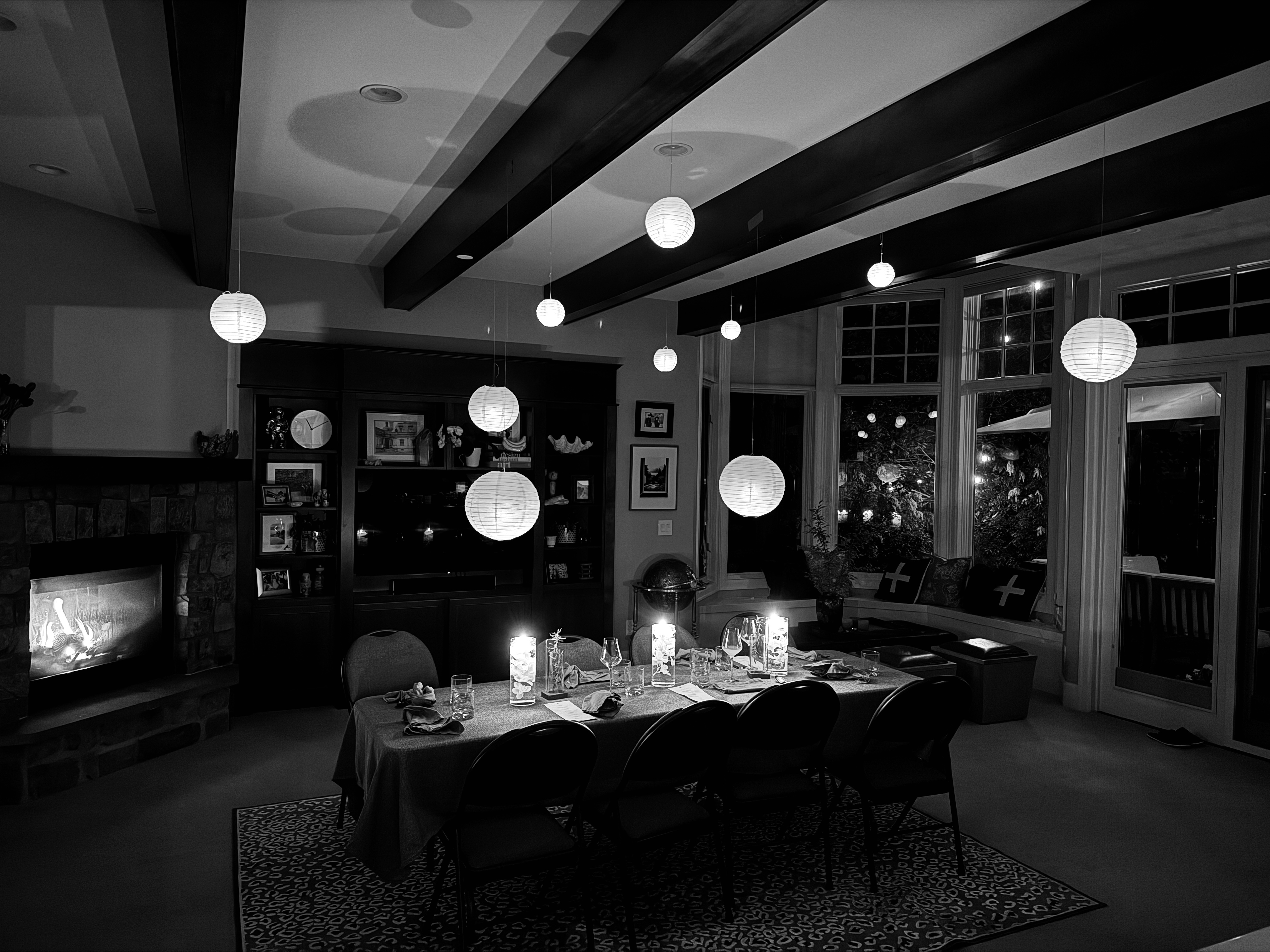 Private wine dinner setup with long candlelit table and paper lanterns