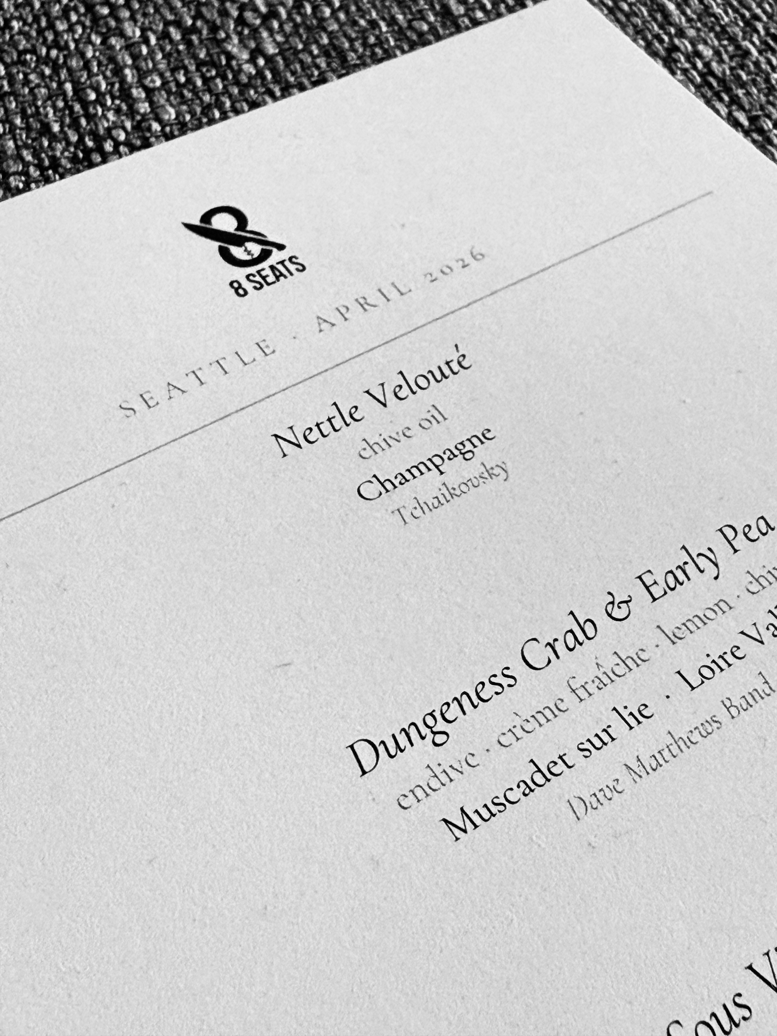 Custom printed menu pairing food, wine, and music for a private dinner