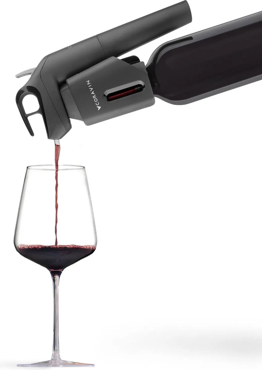 Coravin Timeless Three+ with argon capsules, needle guard, and screw caps, in-use: pouring into a glass, no people